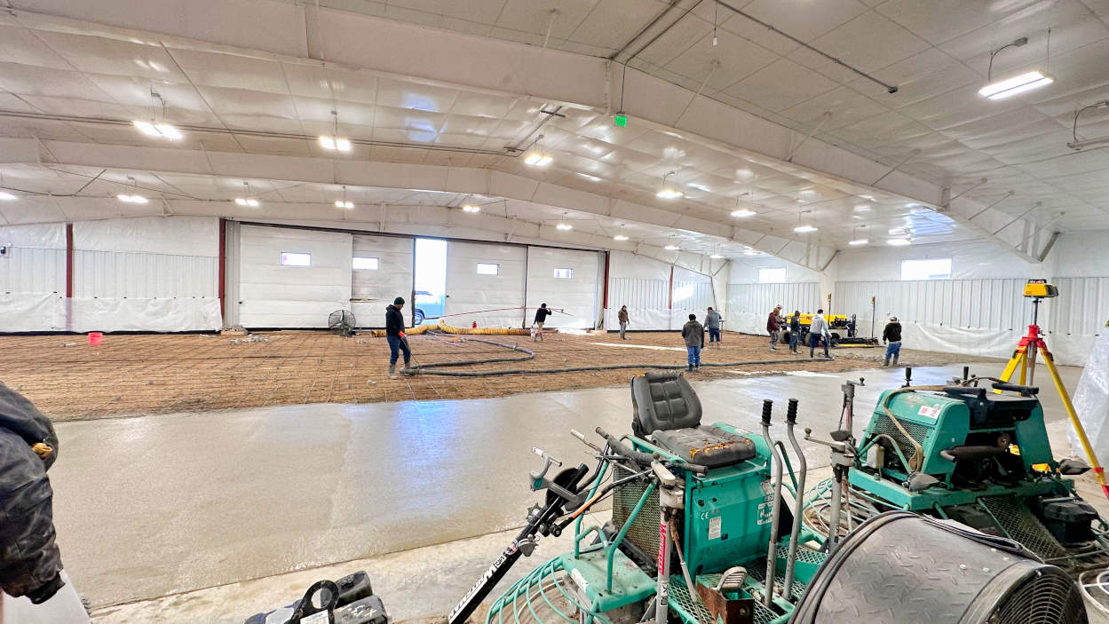 Construction crews laying new concrete in the expanded BAS airplane parts hangar in Colorado