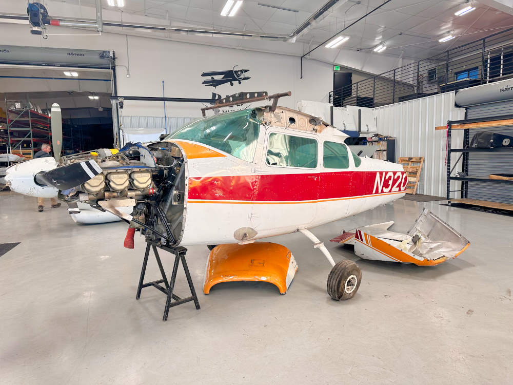 Cessna 182f Skylane with exposed engine and prop in the salvage hangar