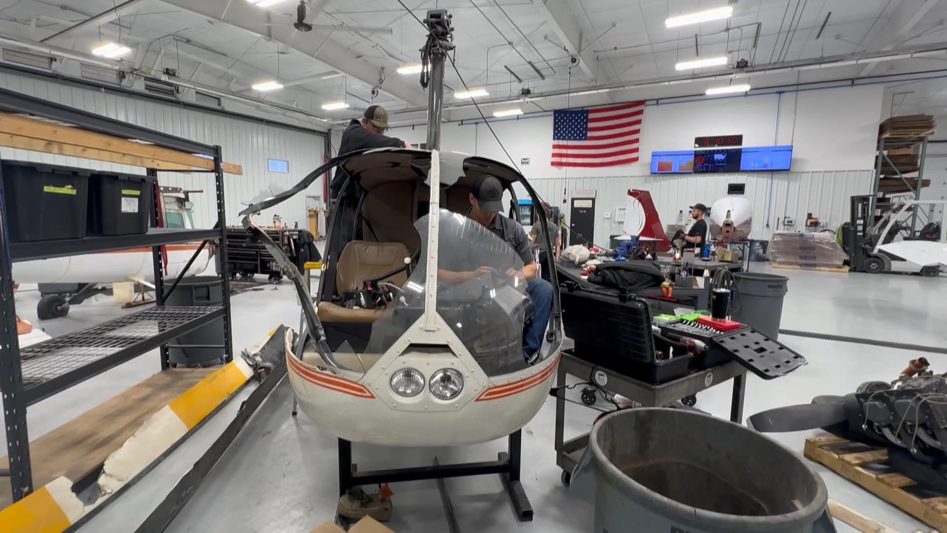 The BAS aviation mechanics disassembling a wrecked Robinson R44 Raven II helicopter