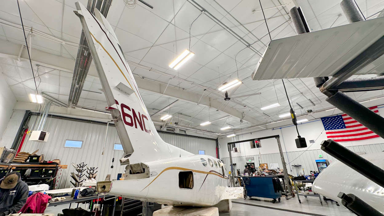 wrecked Cessna 421 in the aircraft salvage hangar tail vertical